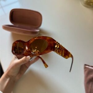 Miu Miu Oval Sunglasses